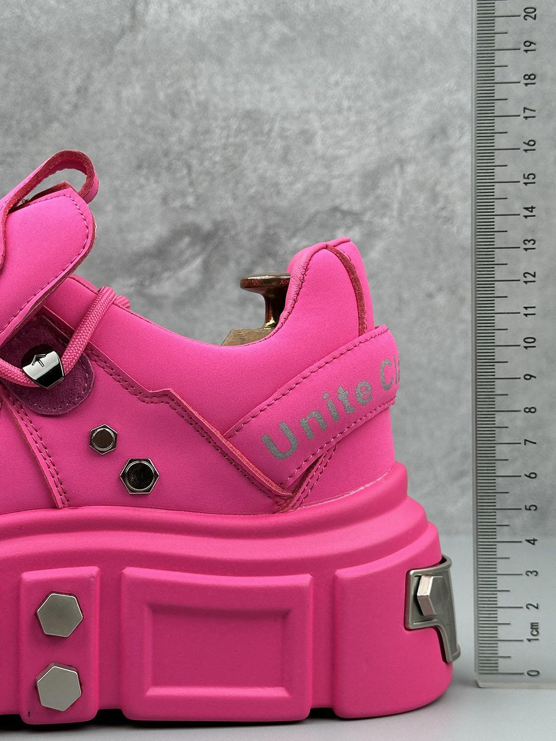 Bright pink derby shoes with chunky soles and rivet details by TALISHKO, highlighting bold style.