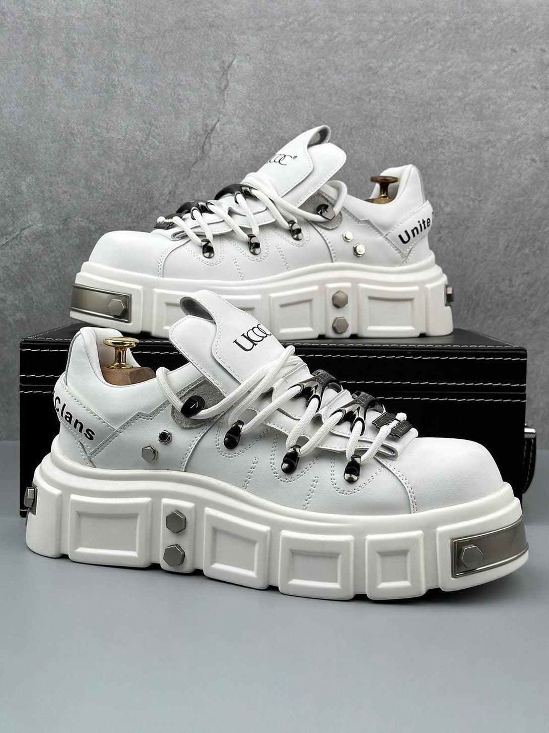 White derby shoes with chunky soles and rivet details by TALISHKO, offering a bold punk vibe.