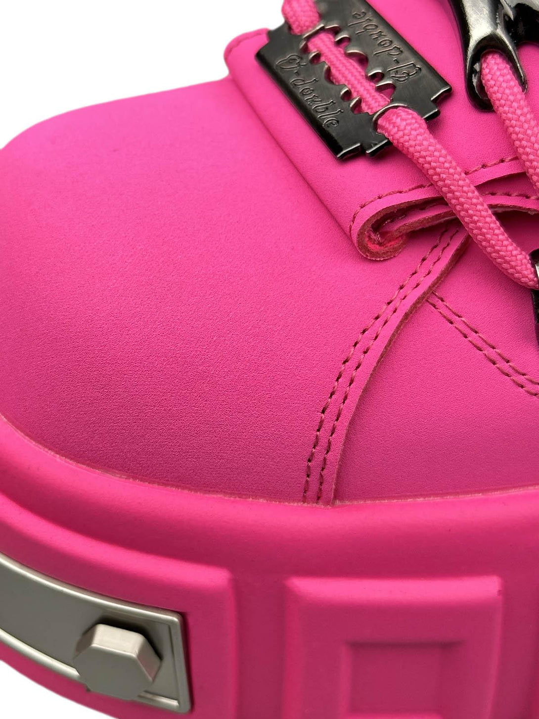 Focusing on bold pink detailing and rivet accents, these TALISHKO shoes exemplify punk flair.