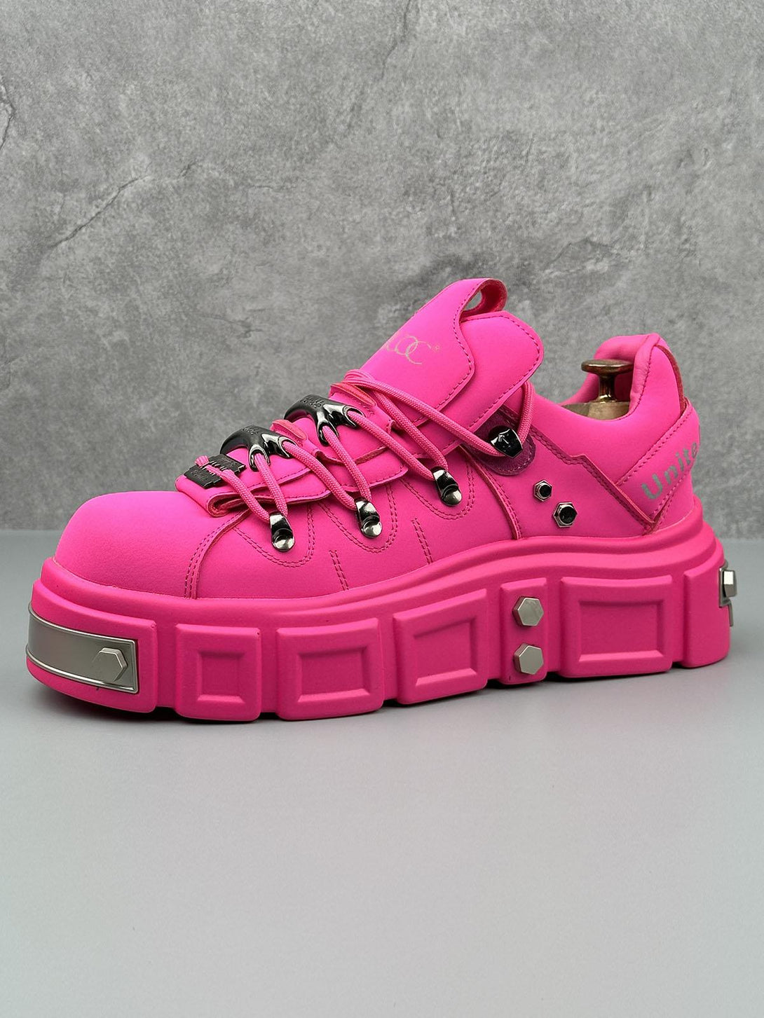 Vibrant pink derby shoes with chunky design and rivet accents by TALISHKO, offering bold flair.
