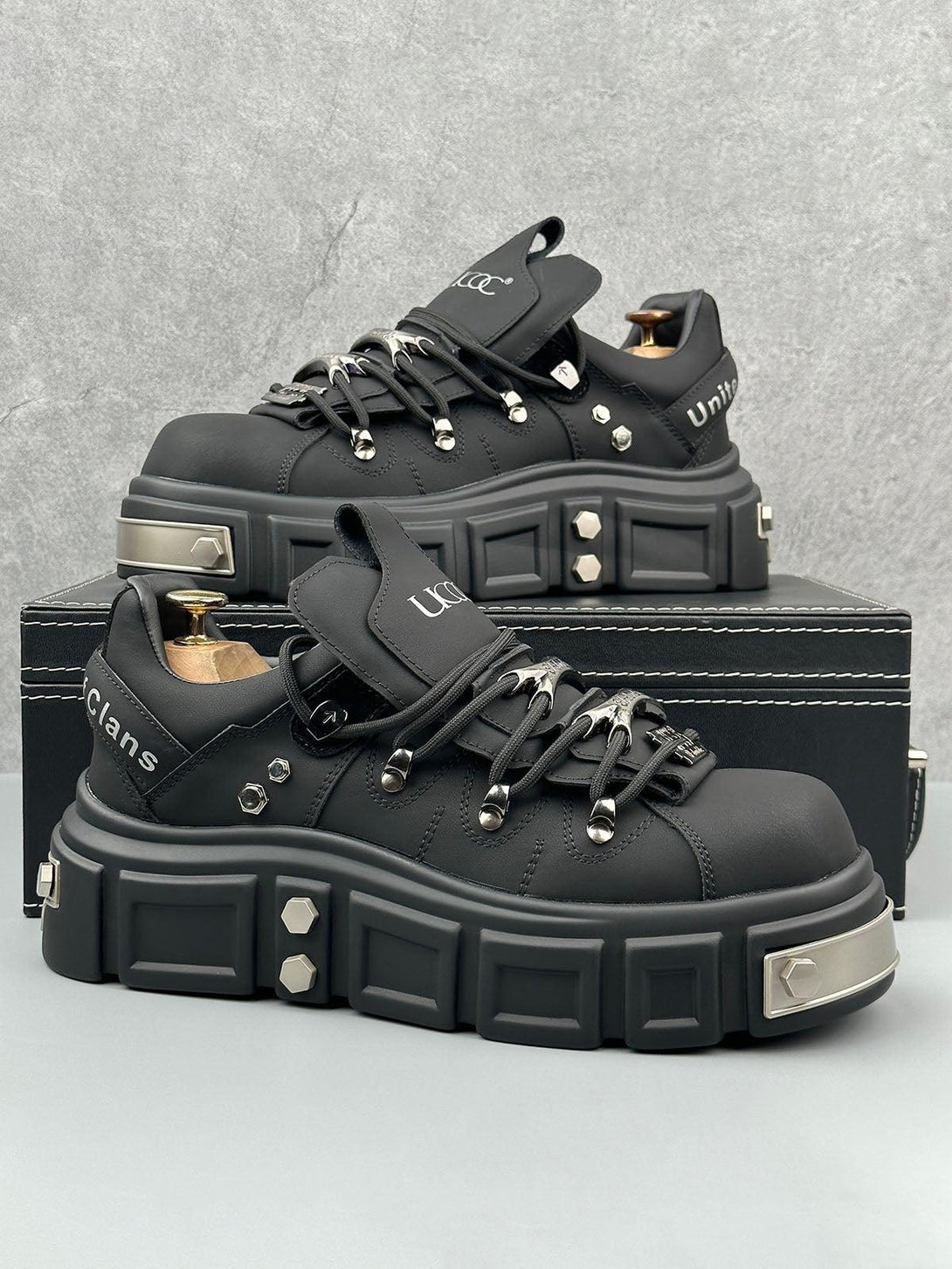 TALISHKO black derby shoes with chunky soles and rivet details, perfect for a punk-inspired look.