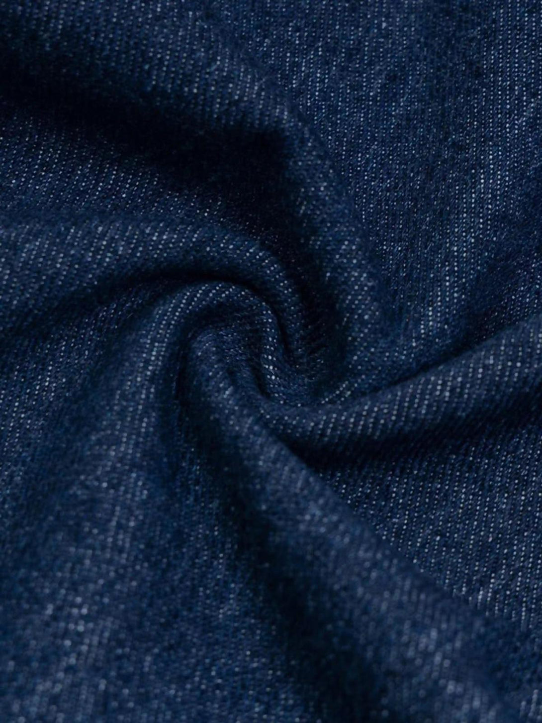 Zoomed-in texture of TALISHKO jeans, highlighting intricate fabric and subtle puppy embroidery.