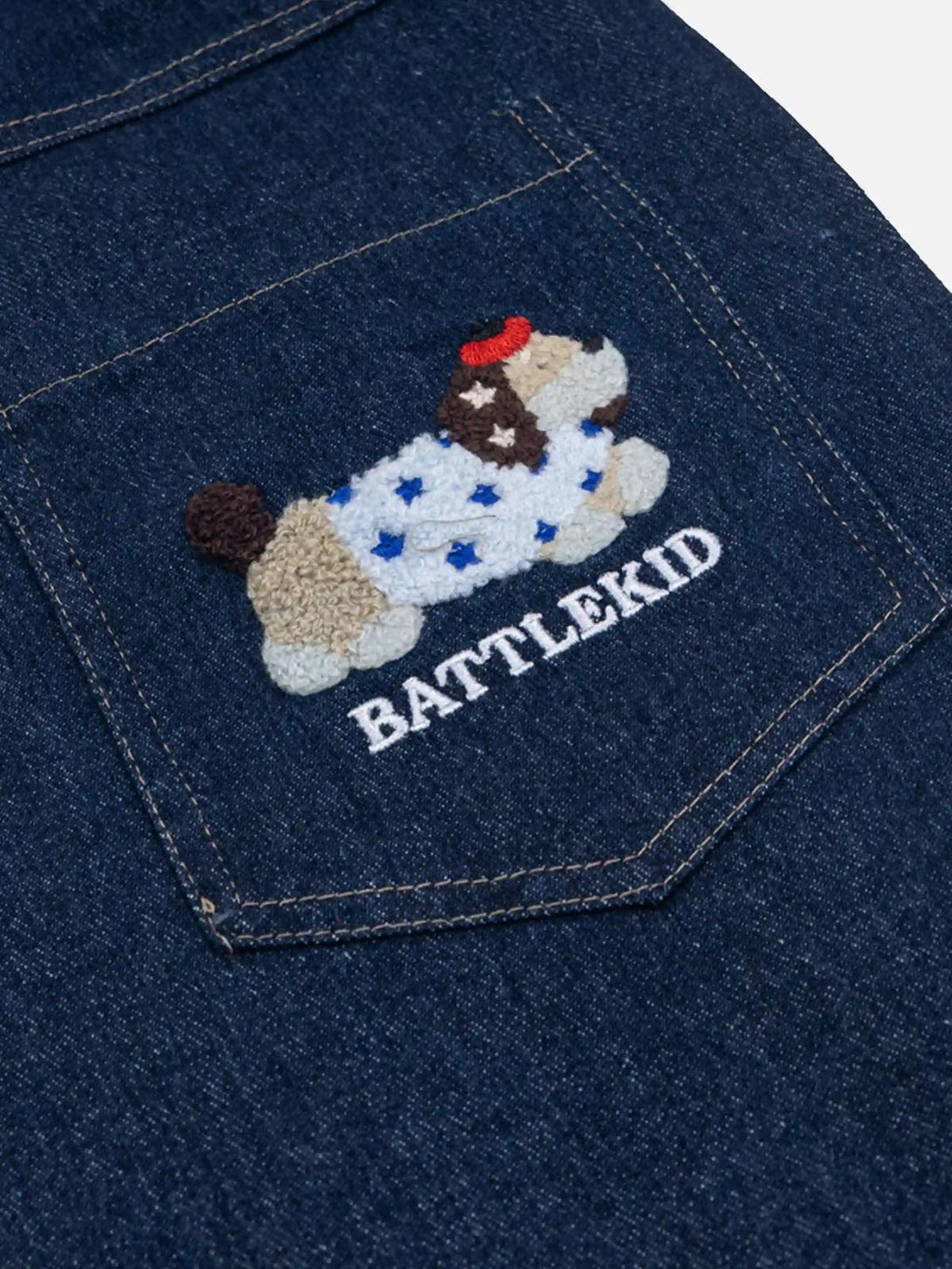 A detailed view of TALISHKO jeans pocket with playful puppy embroidery, adding whimsical charm.