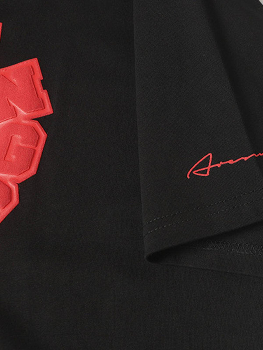 Zoomed-in on TALISHKO's black T-shirt, highlighting the red graphic and sleeve detail.