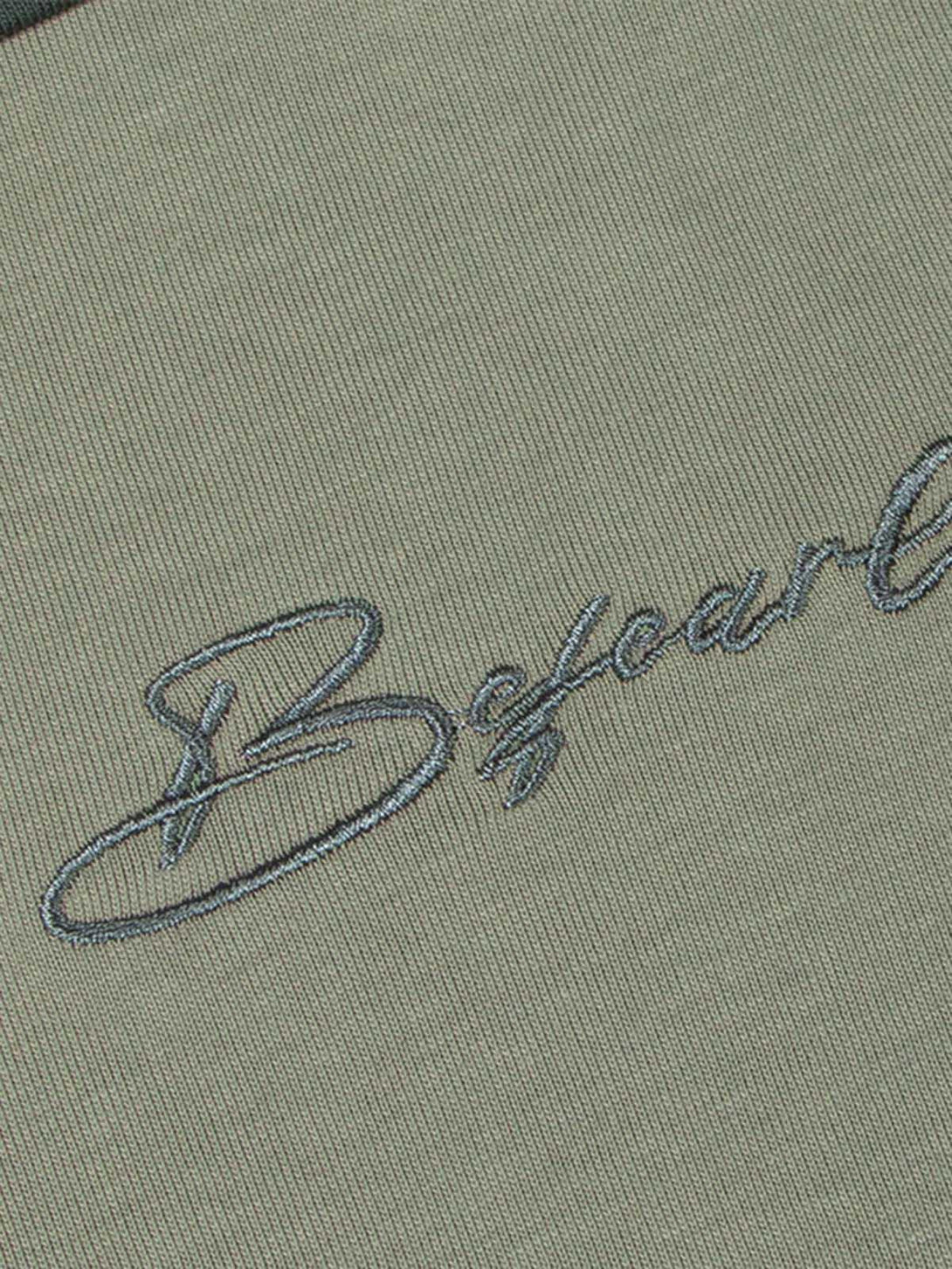 Intricate stitching detail of TALISHKO's quick-dry T-shirt, showcasing elegant embroidery.