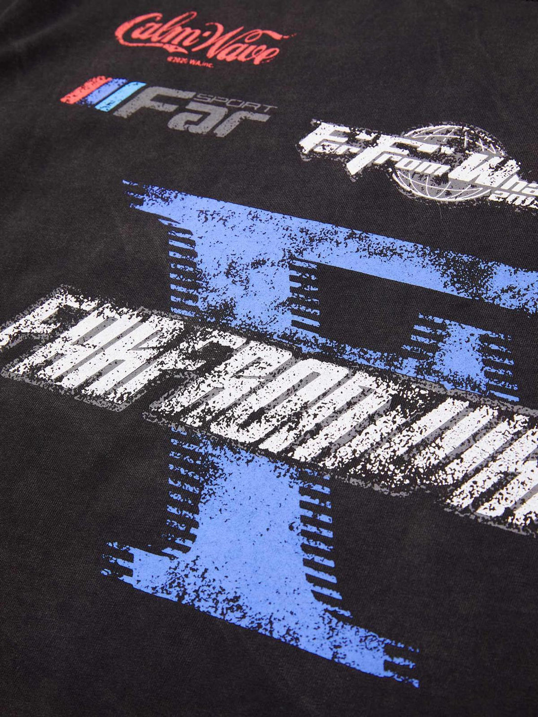 Detailed look at TALISHKO T-shirt highlighting blue racing graphics and bold lettering.