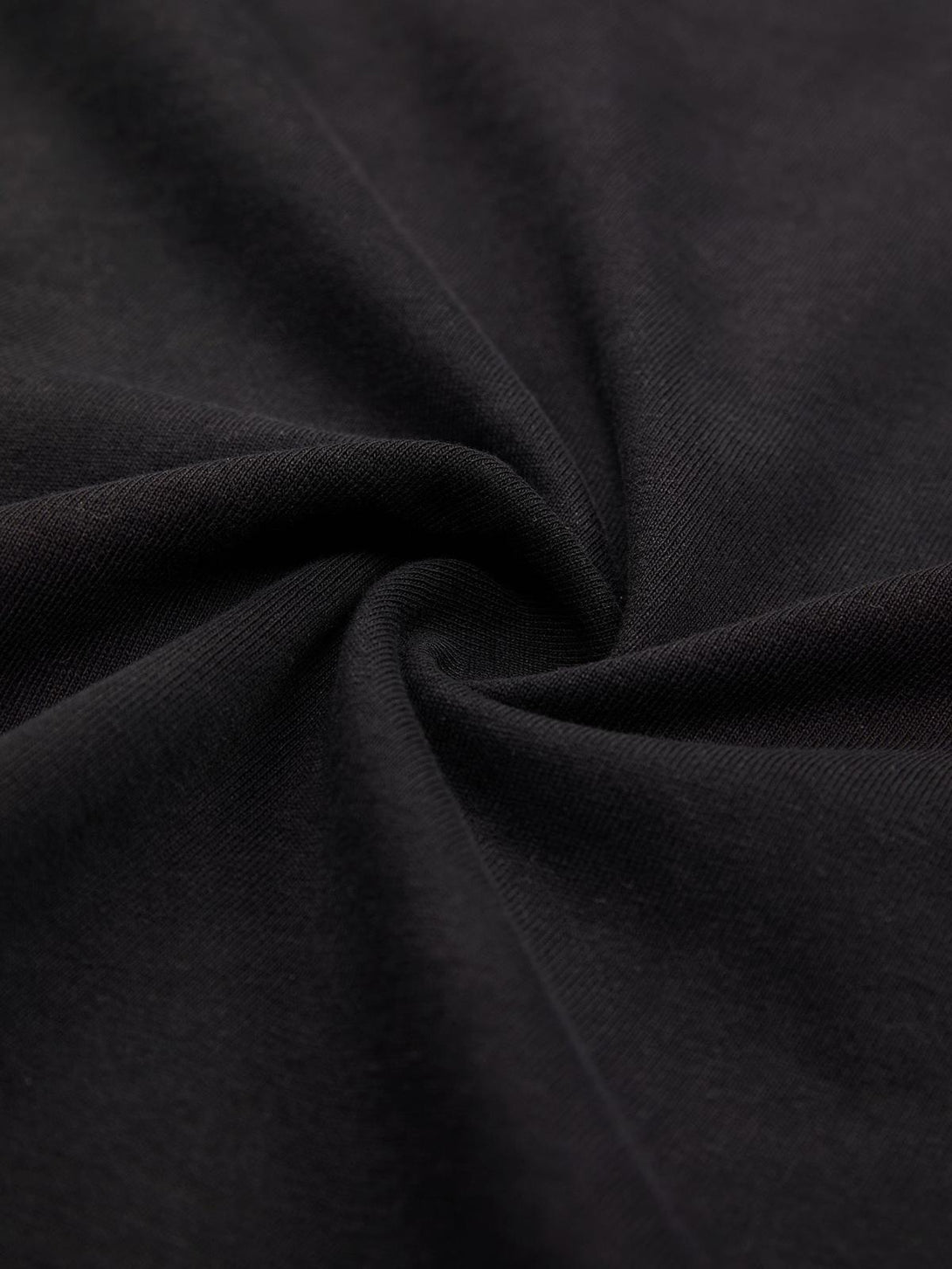 Zoomed-in texture of TALISHKO T-shirt fabric, showcasing its smooth and soft material.