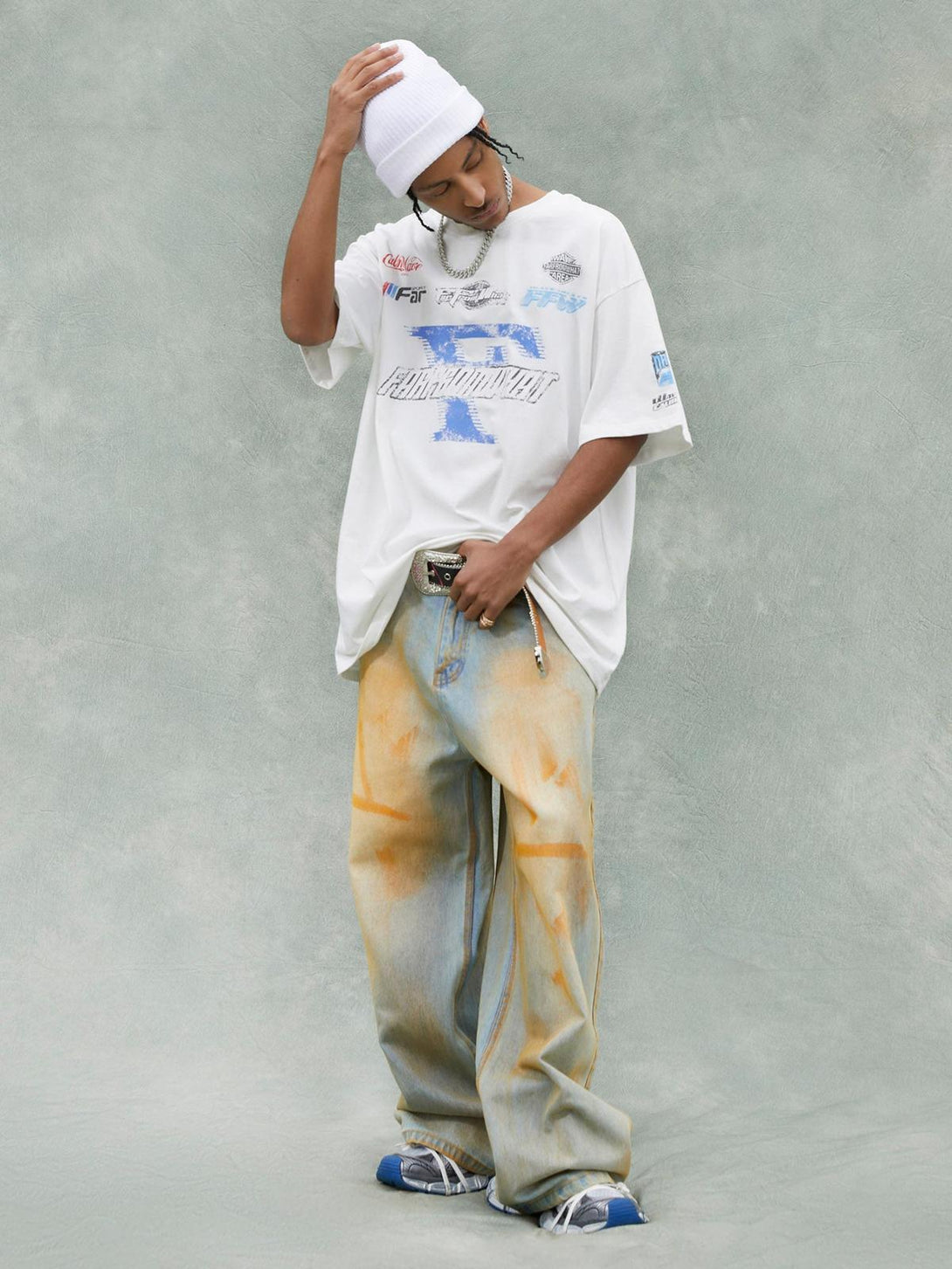 Model in TALISHKO's Racing Afterimage T-shirt, styled with loose denim for a trendy summer look.