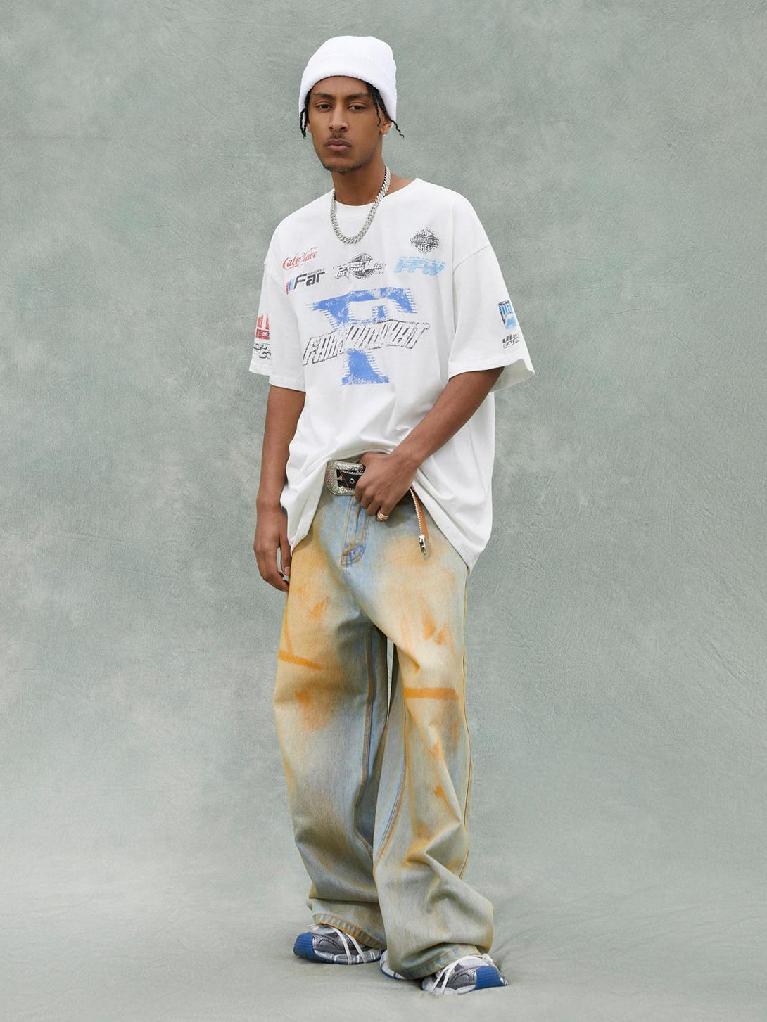 Model wearing TALISHKO Racing Afterimage T-shirt with bold graphics and relaxed denim style.