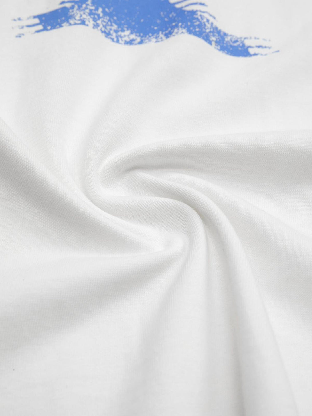 A close-up of TALISHKO T-shirt fabric featuring a soft texture and graphic blue design.