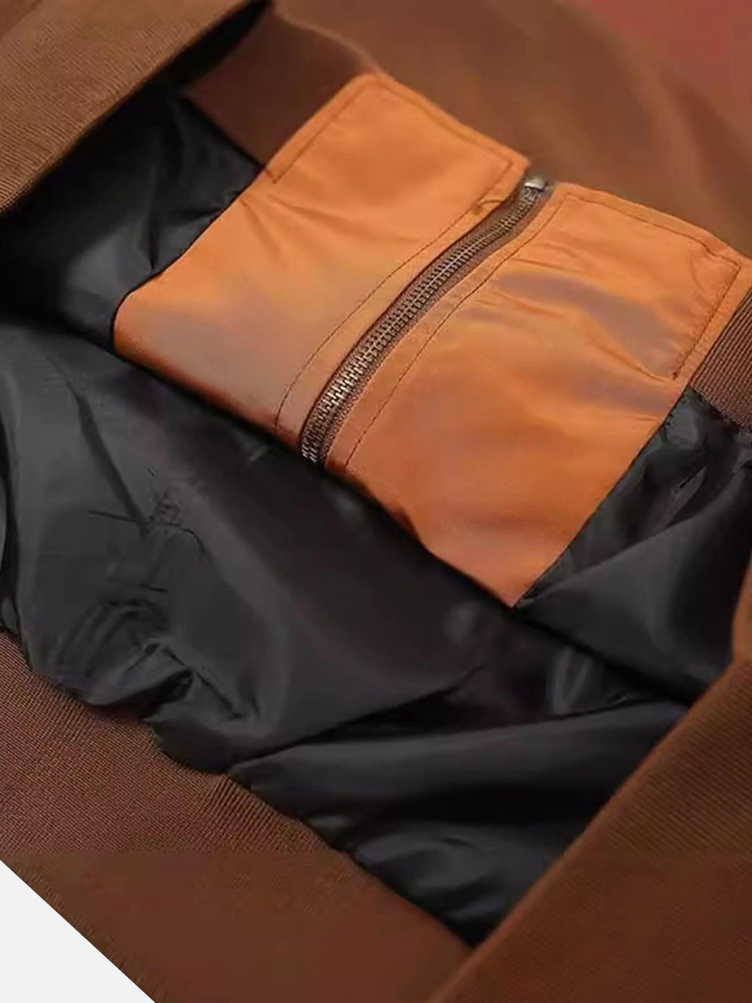 A detailed look at TALISHKO's racing jacket interior, highlighting pocket design and stitching.