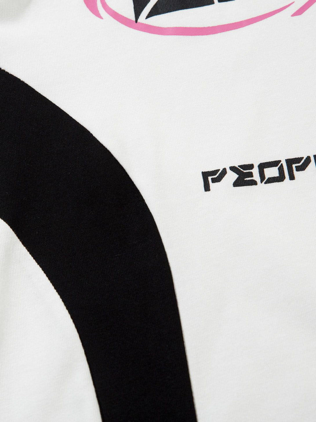 Focusing on the bold graphic design and text detail of a TALISHKO oversized long sleeve T-shirt.