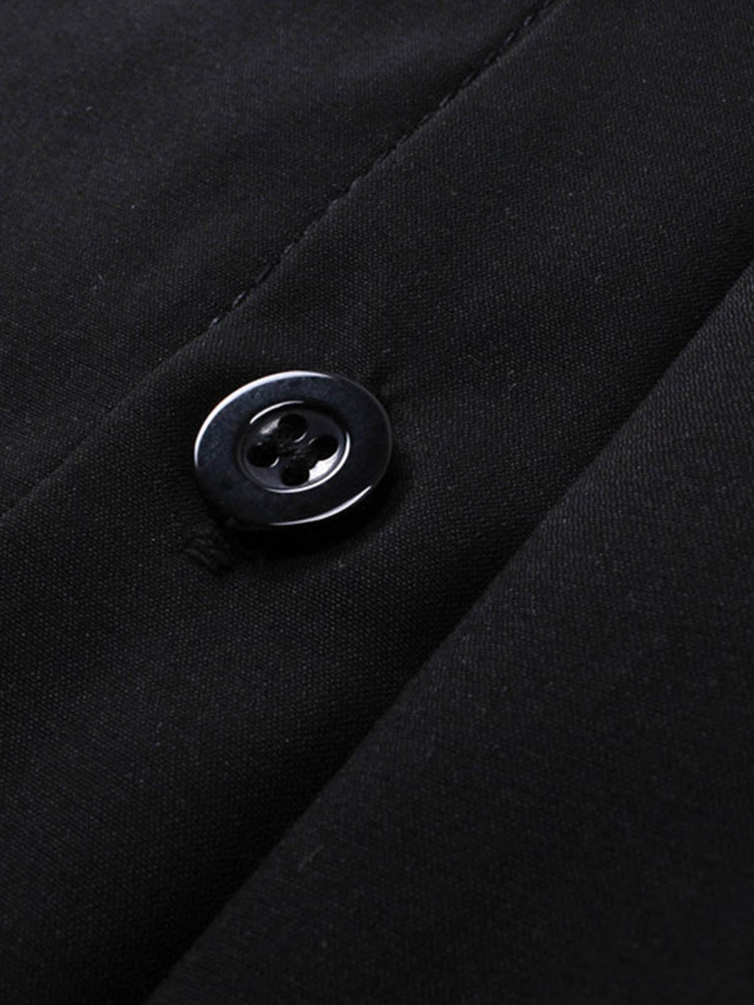 A close-up of the button detail on a black racing-style shirt by TALISHKO.