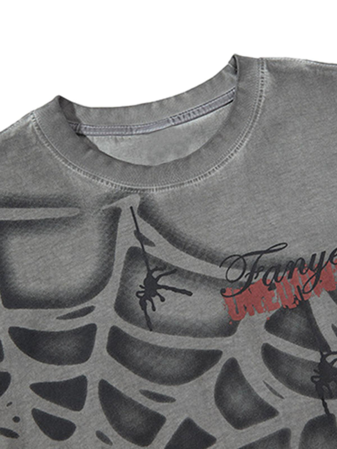 Close-up of a gray vest with spider web design and intricate details by TALISHKO.