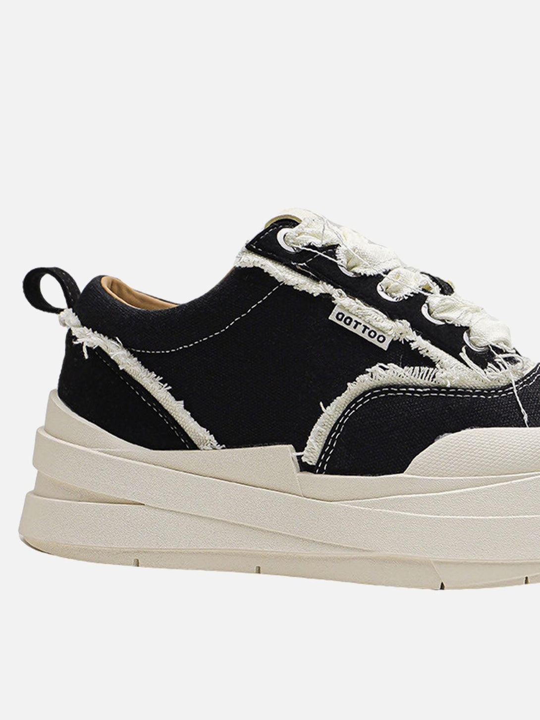 TALISHKO sneakers with distressed black fabric and cream soles, showcasing rugged style.