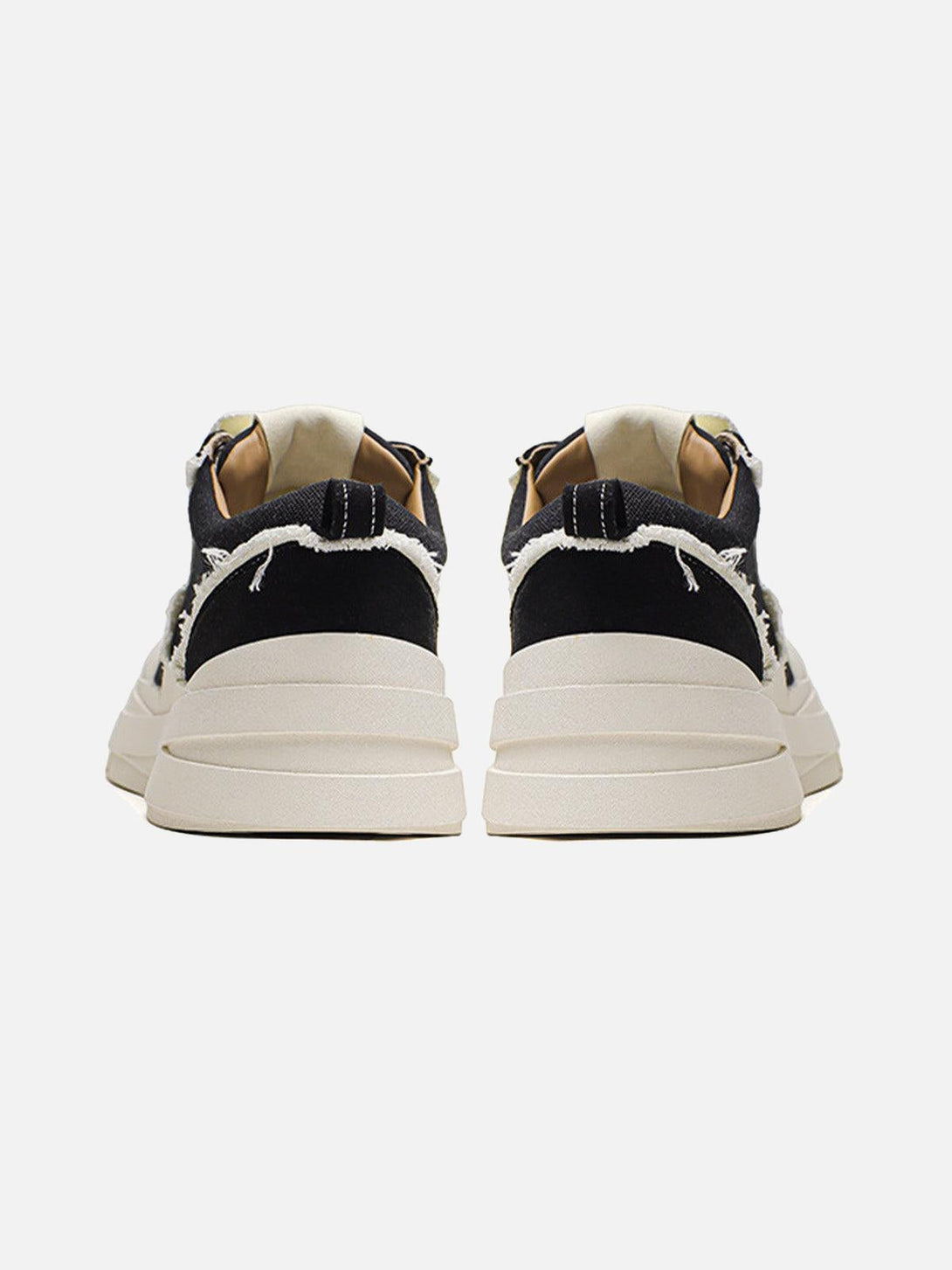 Back view of TALISHKO raggedy round toe sneakers with cream soles and distressed black fabric.