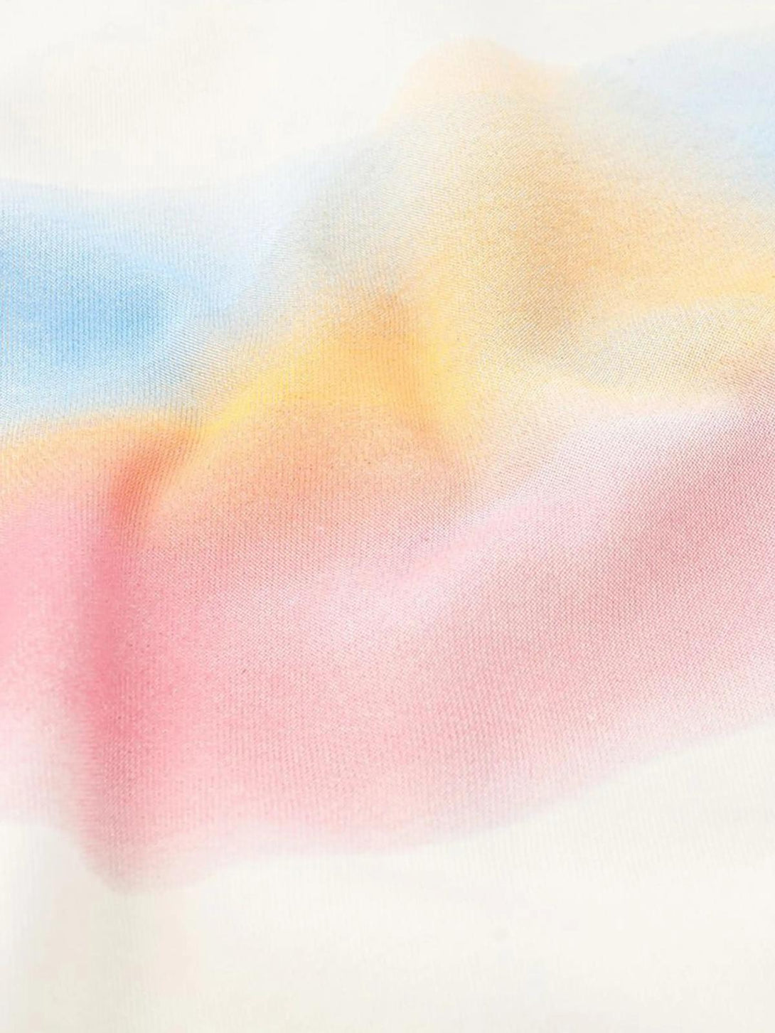 A soft blend of rainbow hues on fabric, highlighting TALISHKO's artistic style.