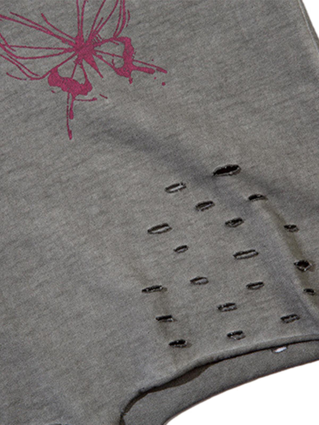 A detailed view of a TALISHKO vest, highlighting distressed raw edges and butterfly design.