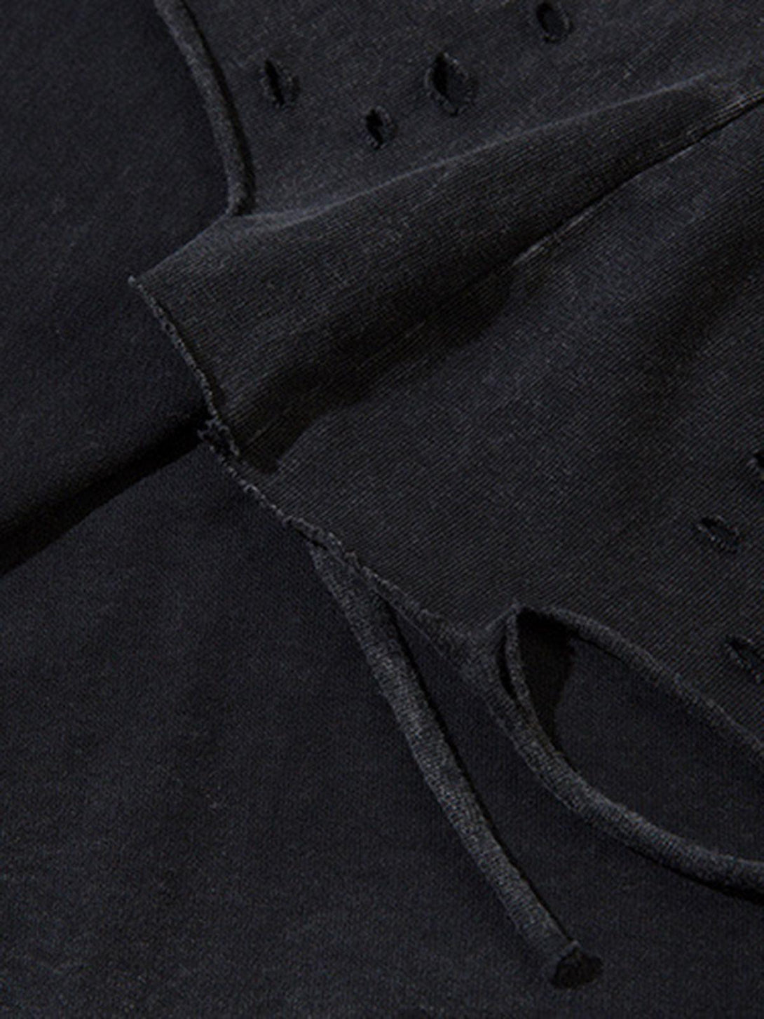 A tight crop highlighting the raw edge details on a TALISHKO vest, emphasizing texture.