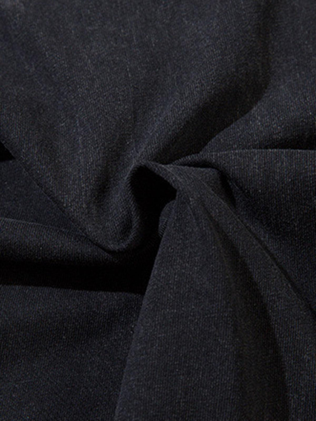 Intricate look at the dark fabric texture of a TALISHKO vest, highlighting its raw edge detail.