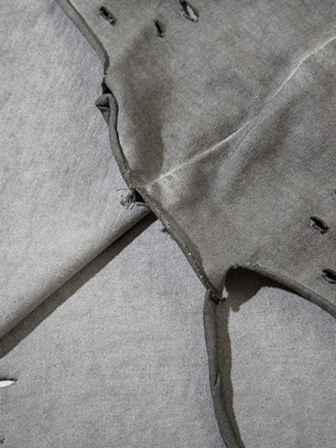 Detailed fabric and stitching of a TALISHKO vest, emphasizing its raw edge design.