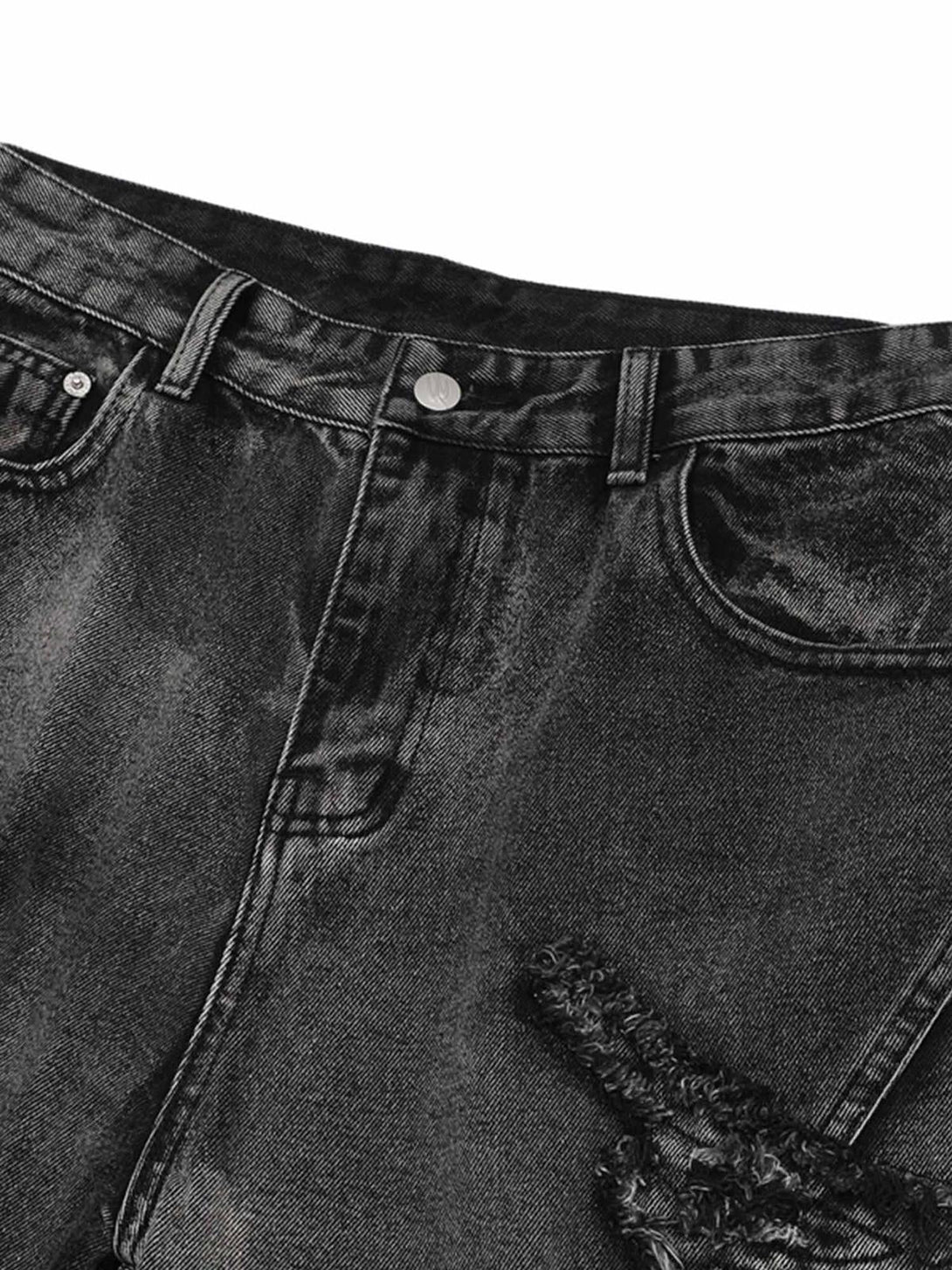 A detailed view of TALISHKO raw edge patch jeans, highlighting unique texture and design.