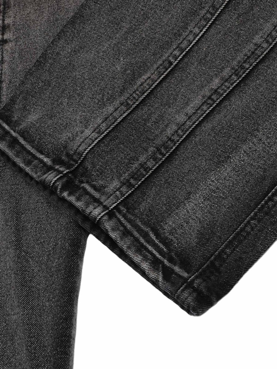 Zoomed-in texture of TALISHKO raw edge patch straight jeans, highlighting intricate stitching.