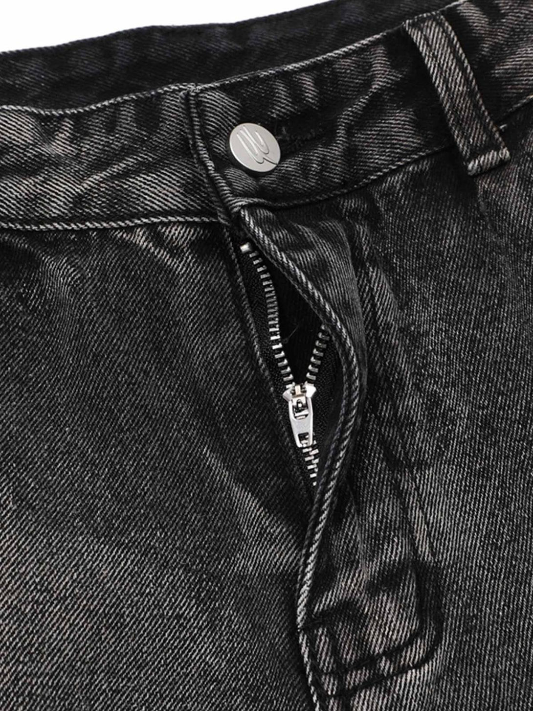 Close-up of TALISHKO raw edge patch straight jeans, detailing zipper and button design.