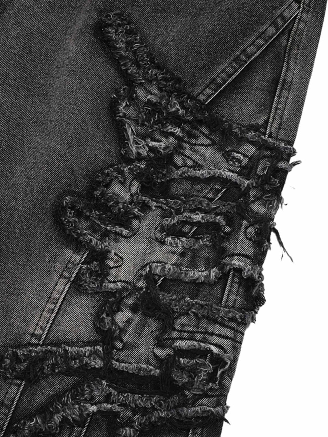 Intricate look at TALISHKO raw edge patch jeans, highlighting unique texture and style.