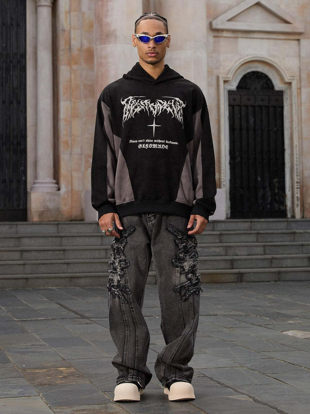 Model showcasing TALISHKO raw edge patch straight jeans and hoodie, exuding urban street style.