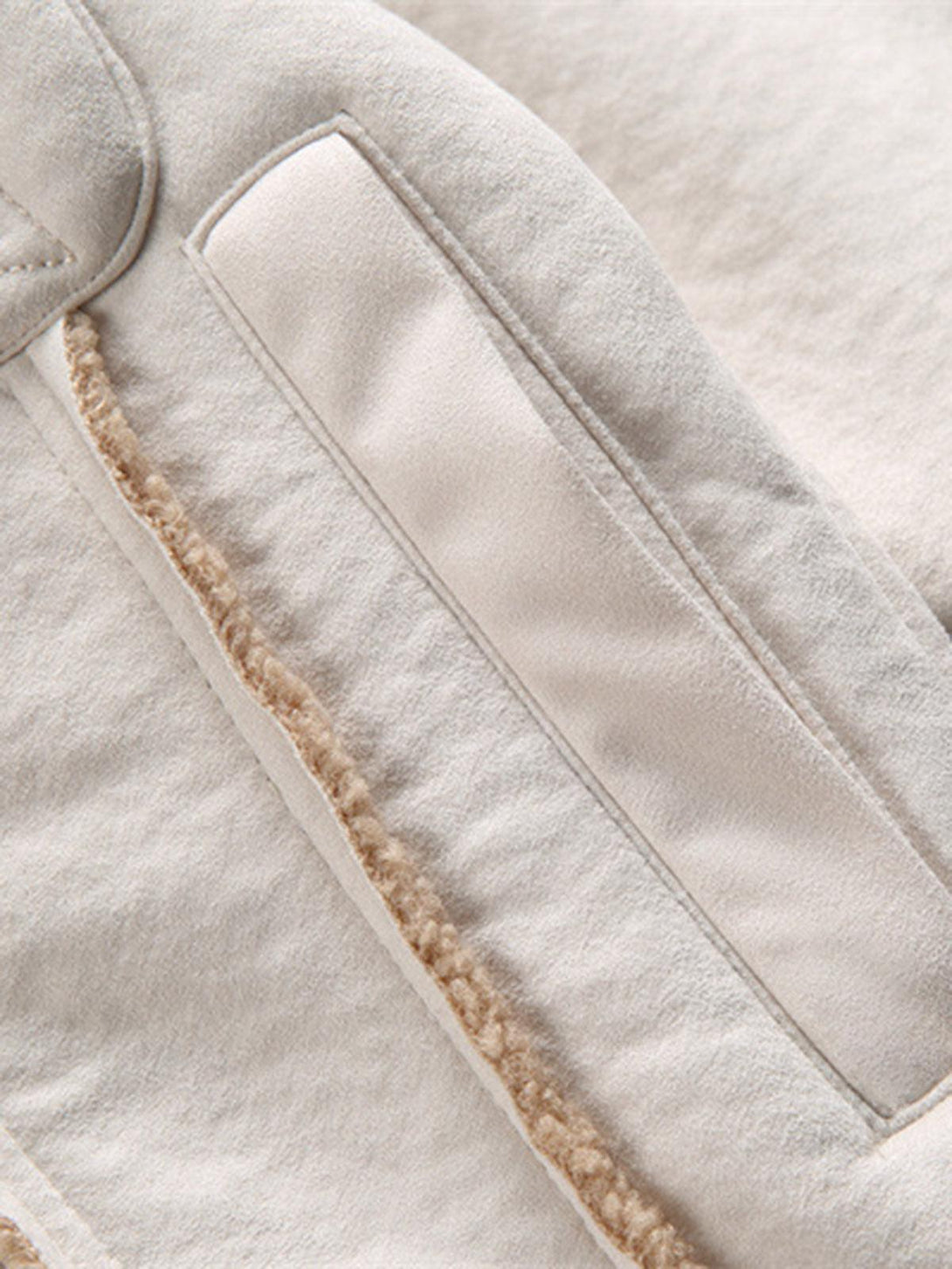 Detailed fabric and stitching of TALISHKO fleece jacket highlighting raw edge design.