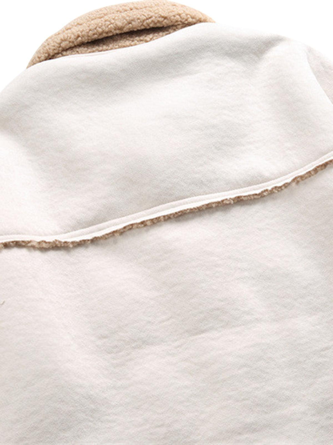 A detailed look at the back of a TALISHKO fleece jacket, showcasing raw edge design.