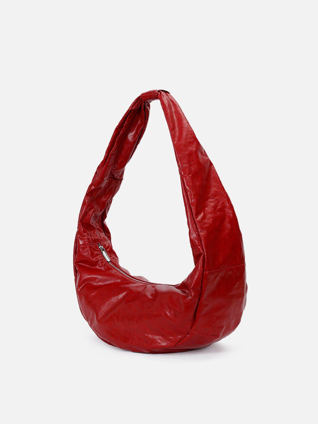 A modern red faux leather bag by TALISHKO with a diagonal design, ideal for chic ensembles.