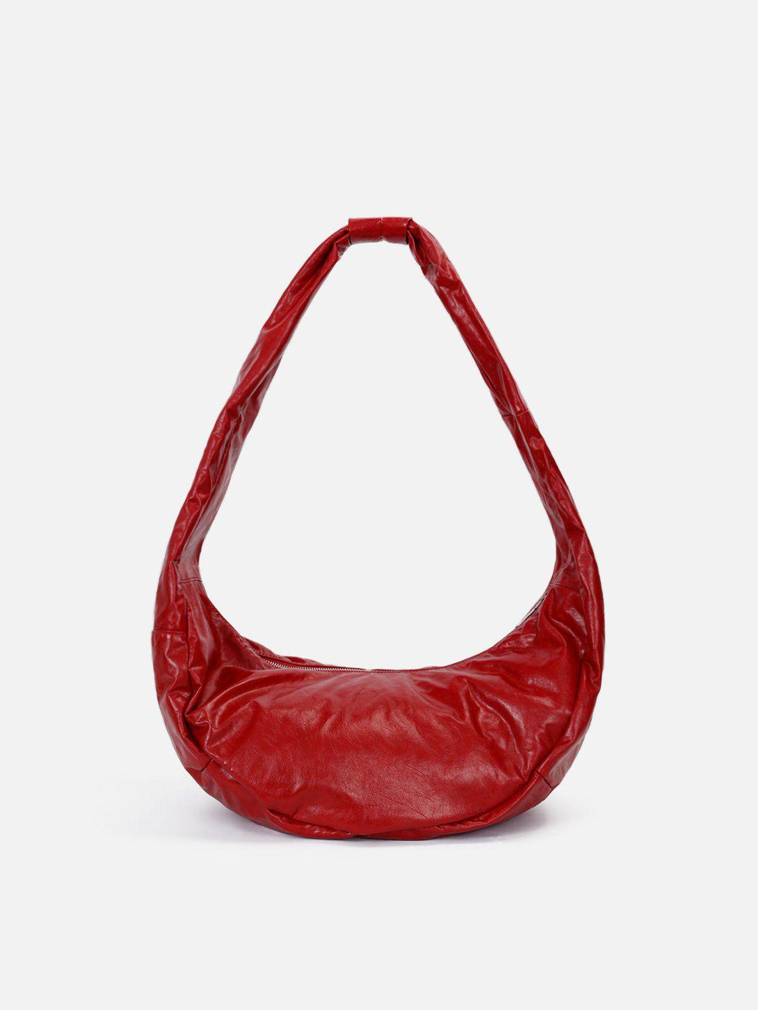 Red faux leather bag by TALISHKO, featuring a unique diagonal design and vibrant color.