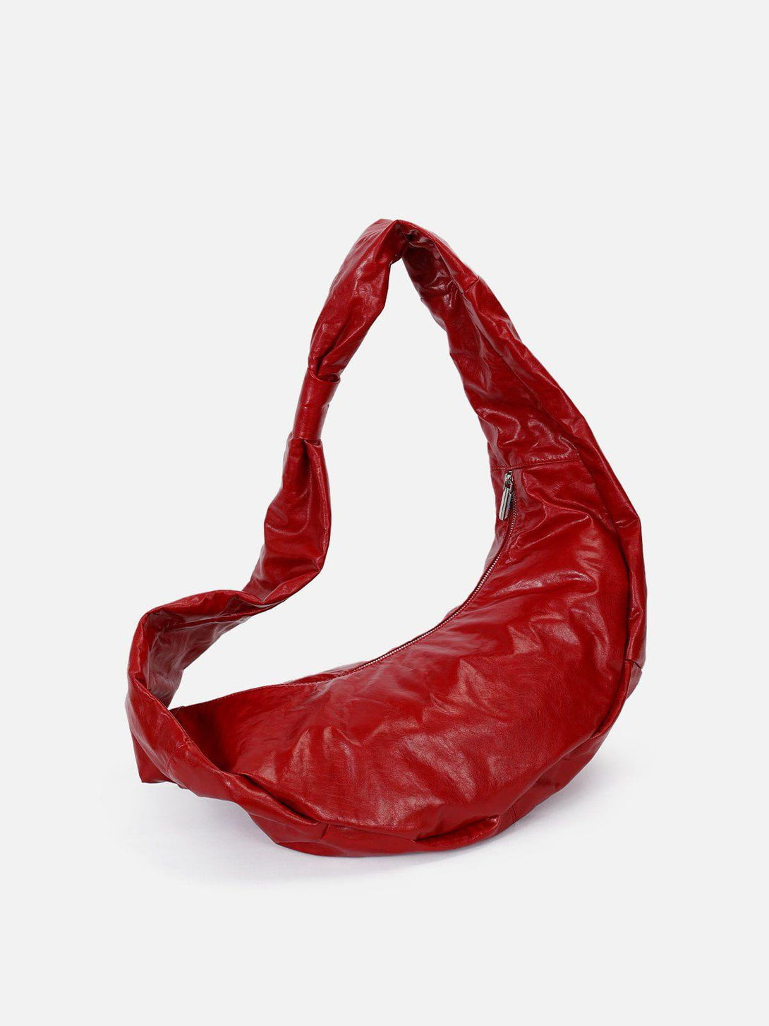 TALISHKO's red faux leather diagonal bag, showcasing a unique shape and bold color.