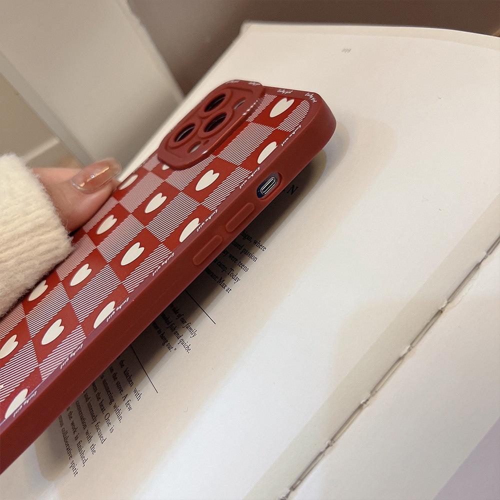 A side view of TALISHKO's red love lattice iPhone case, showcasing playful heart designs.