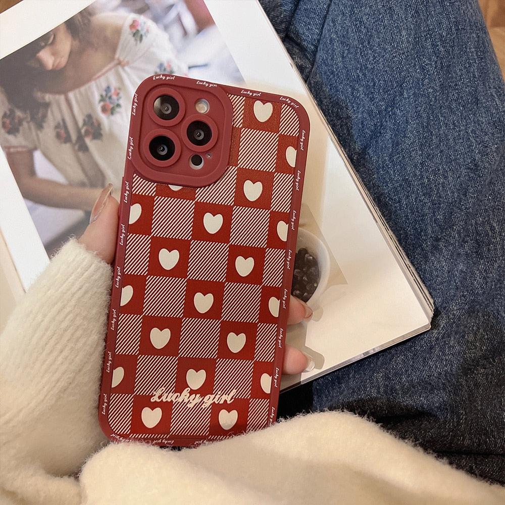 A cozy, detailed look at TALISHKO's red love lattice iPhone case with charming heart patterns.