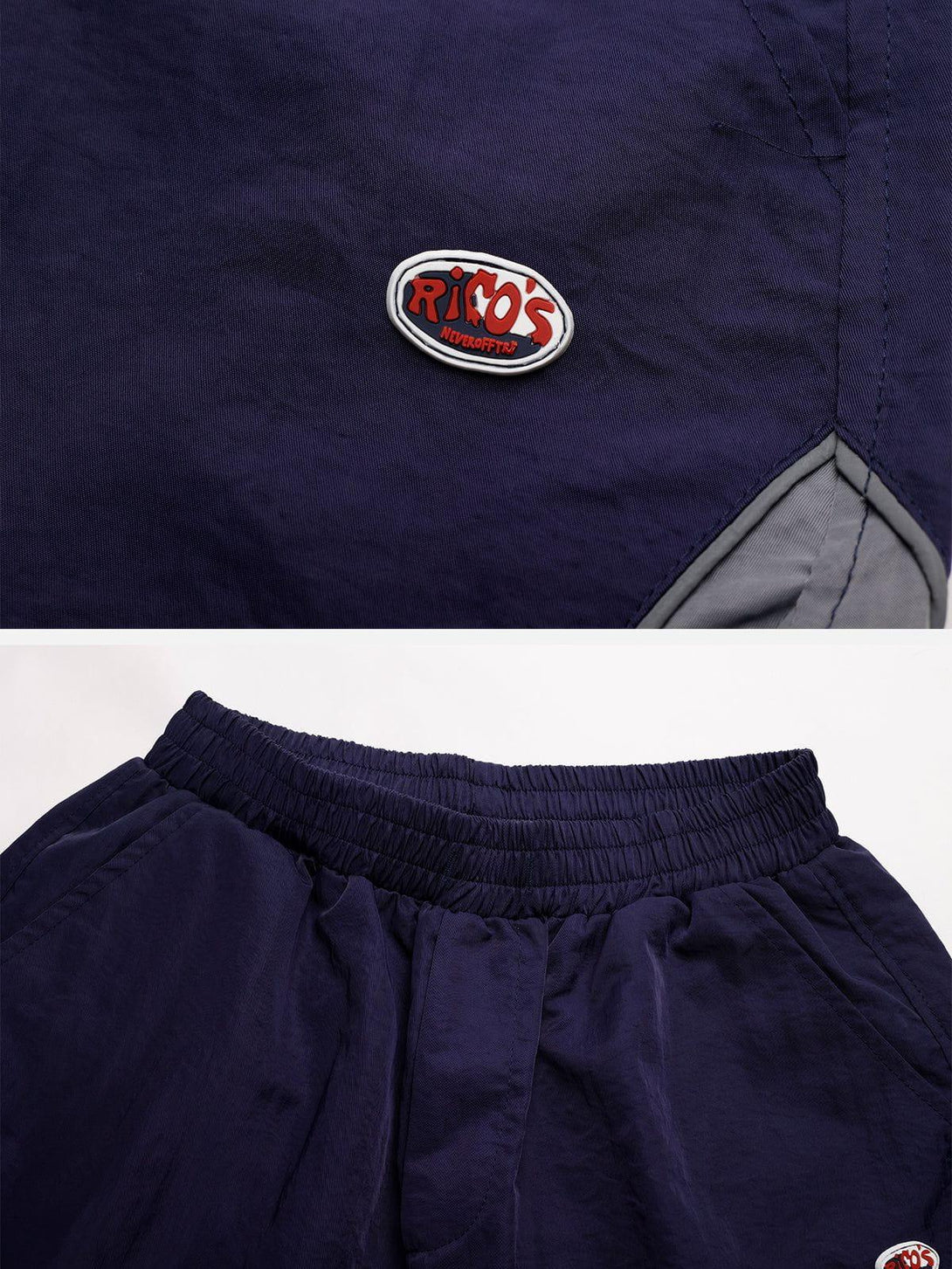 Detailed view of TALISHKO training shorts in navy, highlighting fabric texture and logo detail.