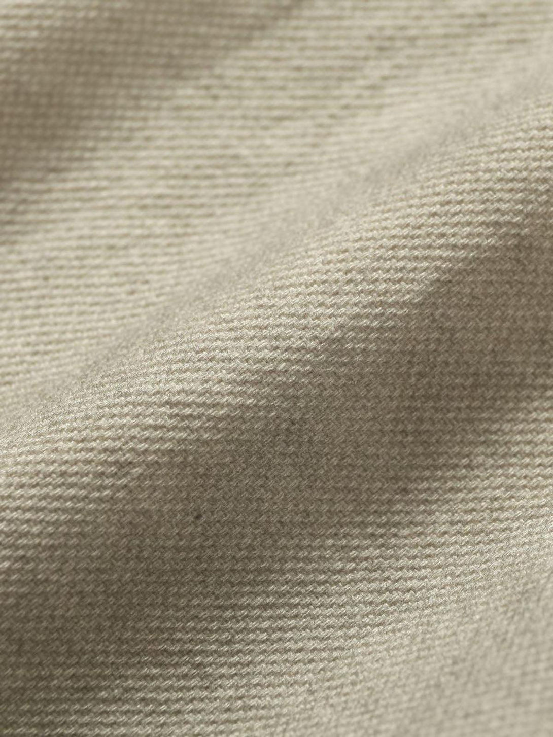 Zoomed-in texture of TALISHKO jacket fabric, highlighting its intricate weave and design.