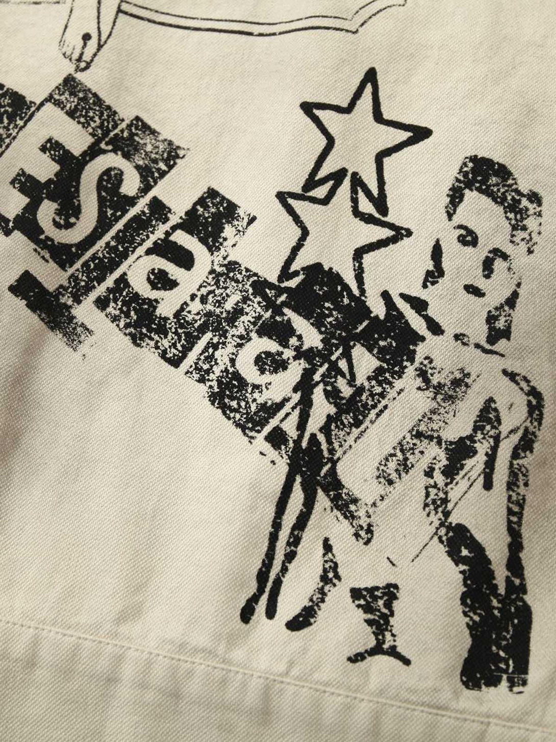 Intricate look at TALISHKO jacket's graphic design and star motifs on textured fabric.