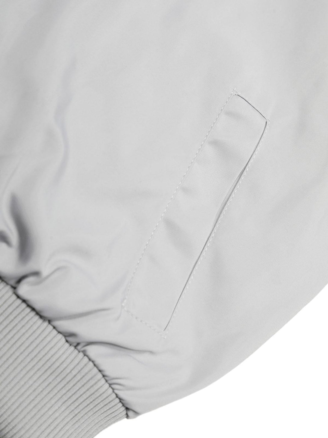 A detailed view of TALISHKO retro jacket pocket, highlighting sleek stitching and ribbed hem.