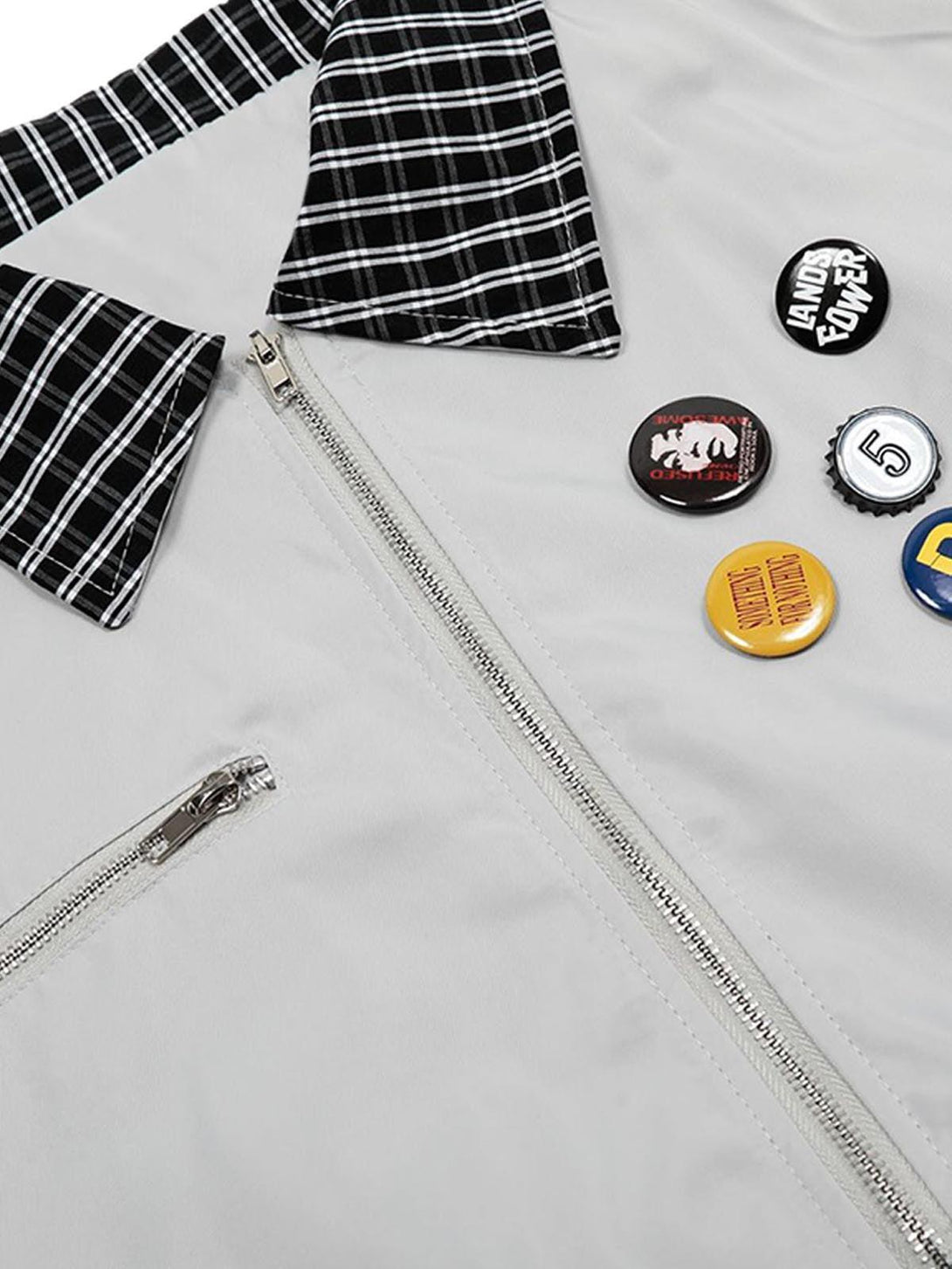 A detailed look at a TALISHKO retro jacket, showcasing badges and a checkered collar.