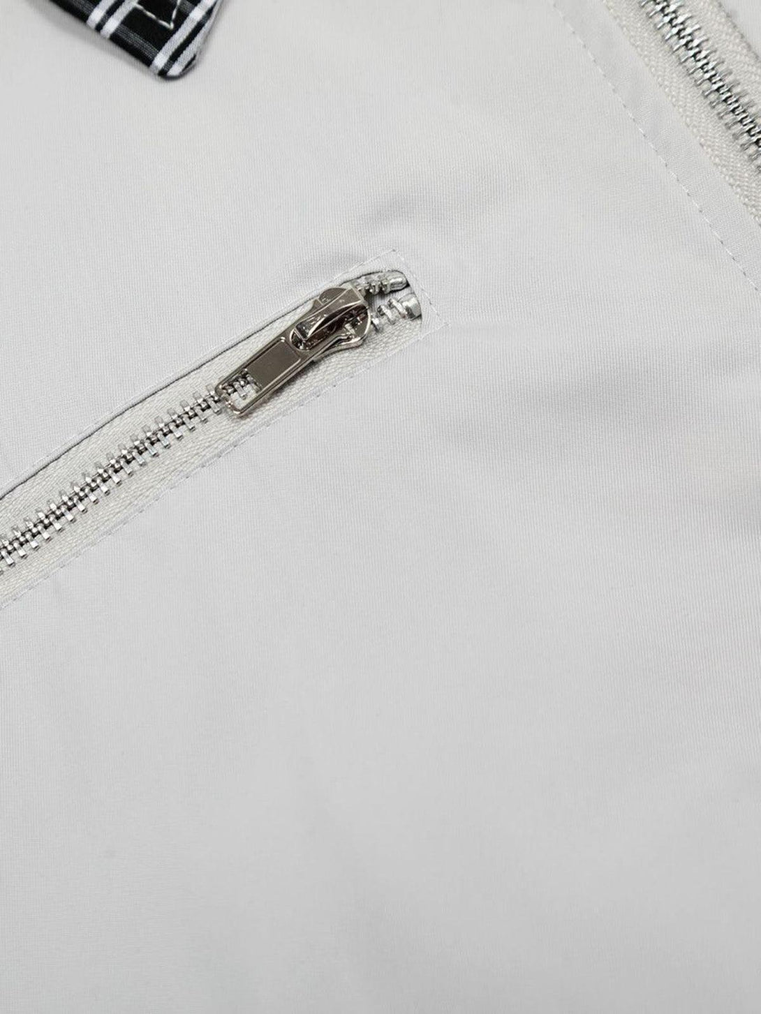 Detailed view of TALISHKO retro jacket, featuring a sleek zipper and textured fabric.