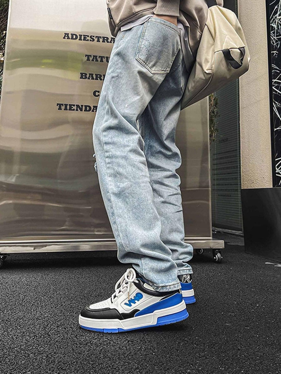 TALISHKO sneakers paired with light denim, highlighting a bold urban streetwear look.