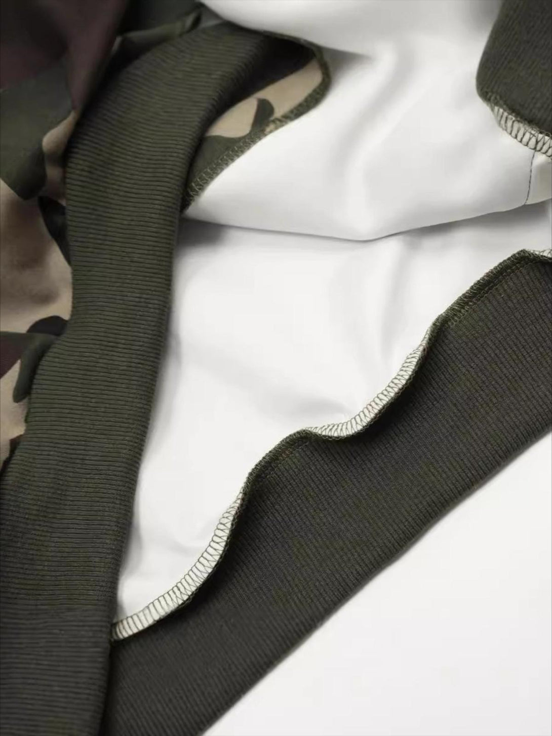Intricate look at the stitching and fabric of TALISHKO's retro camo hoodie.
