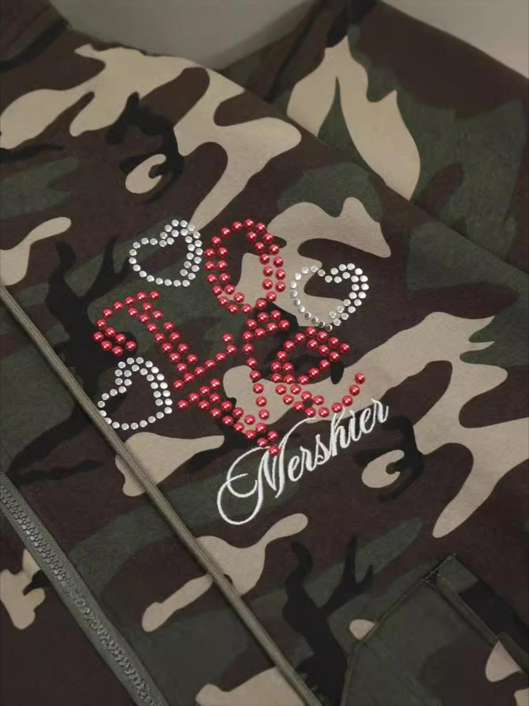 "Intricate design detail on the retro camo hoodie by TALISHKO, highlighting rhinestone embellishments."
