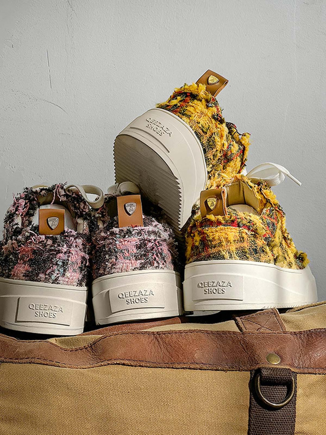 Retro canvas sneakers by TALISHKO in vibrant textures, displayed on a rustic brown bag.