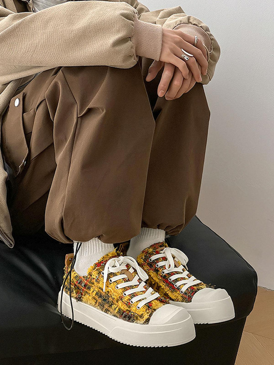 Cozy style with TALISHKO sneakers, showcasing vibrant multicolored texture and white soles.