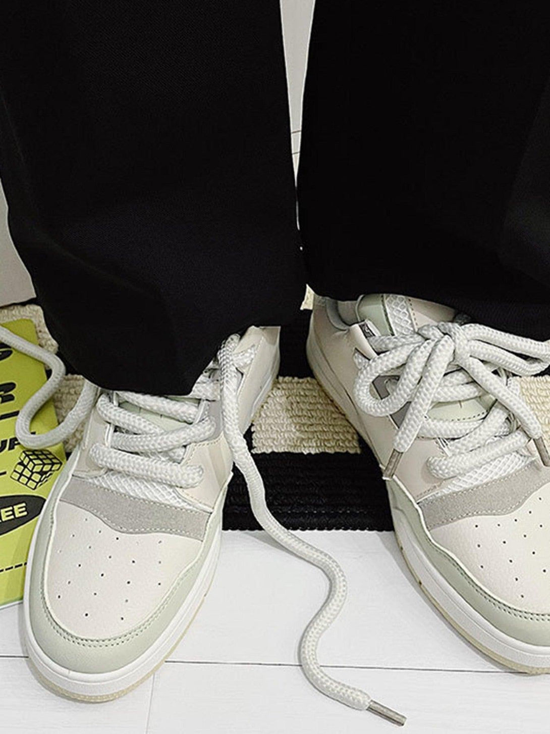 TALISHKO retro casual board shoes in neutral tones, paired with relaxed black pants.