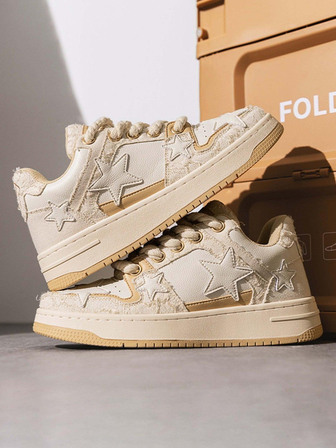TALISHKO retro casual sneakers with star accents stacked, showcasing textured beige design.